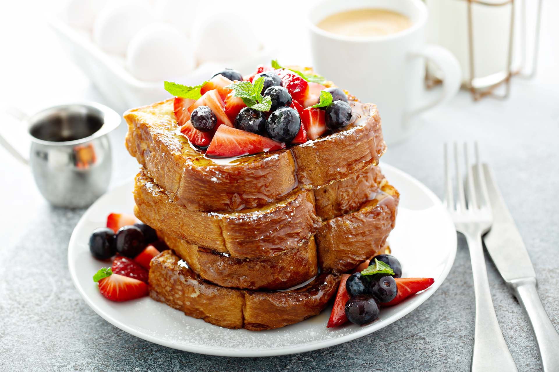 French toast topped with fresh berries and mint.
