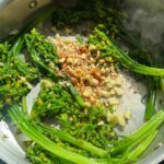 Brown Butter Hazelnut Broccolini searing in a pan.