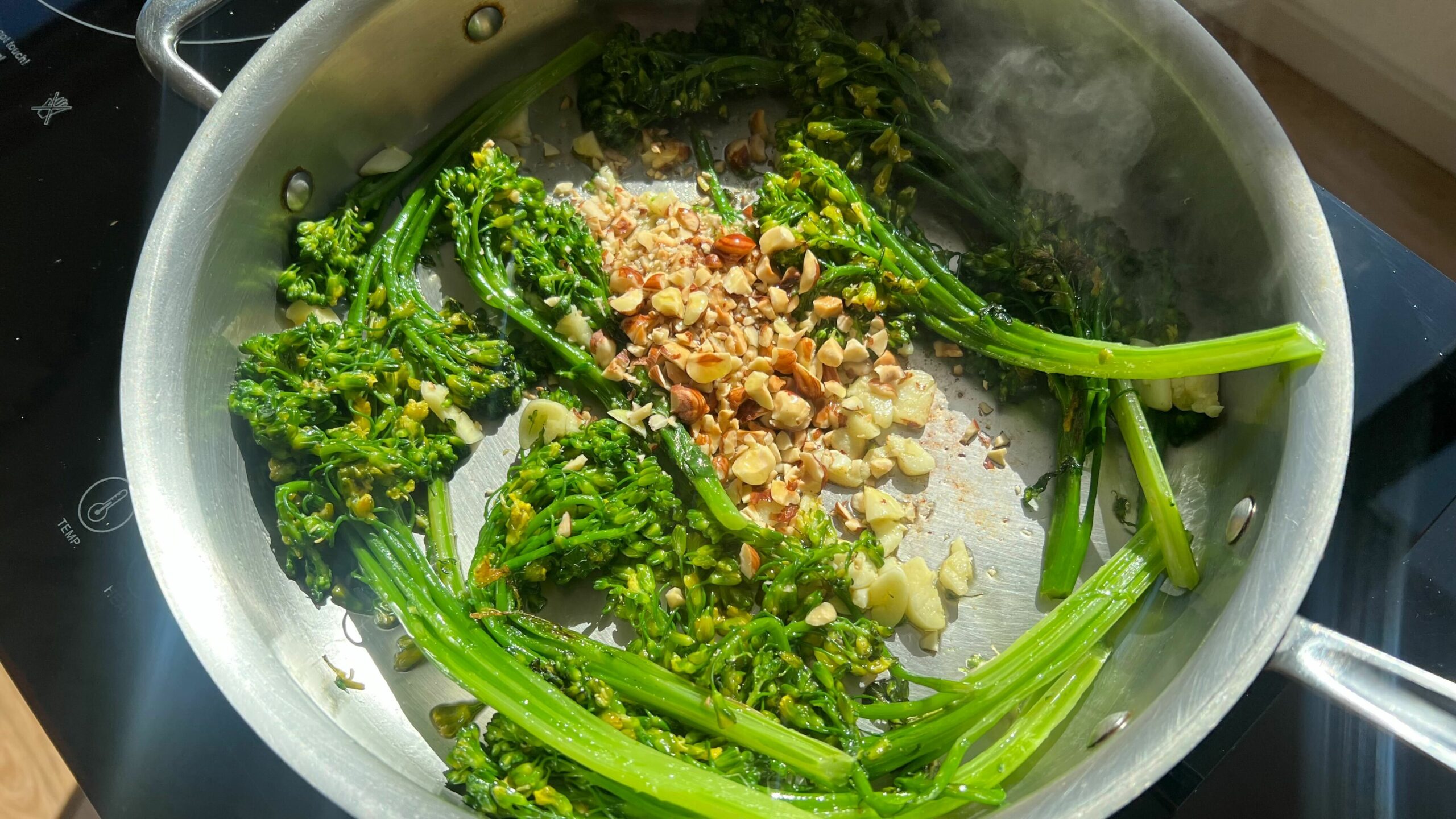 Brown Butter Hazelnut Broccolini searing in a pan.