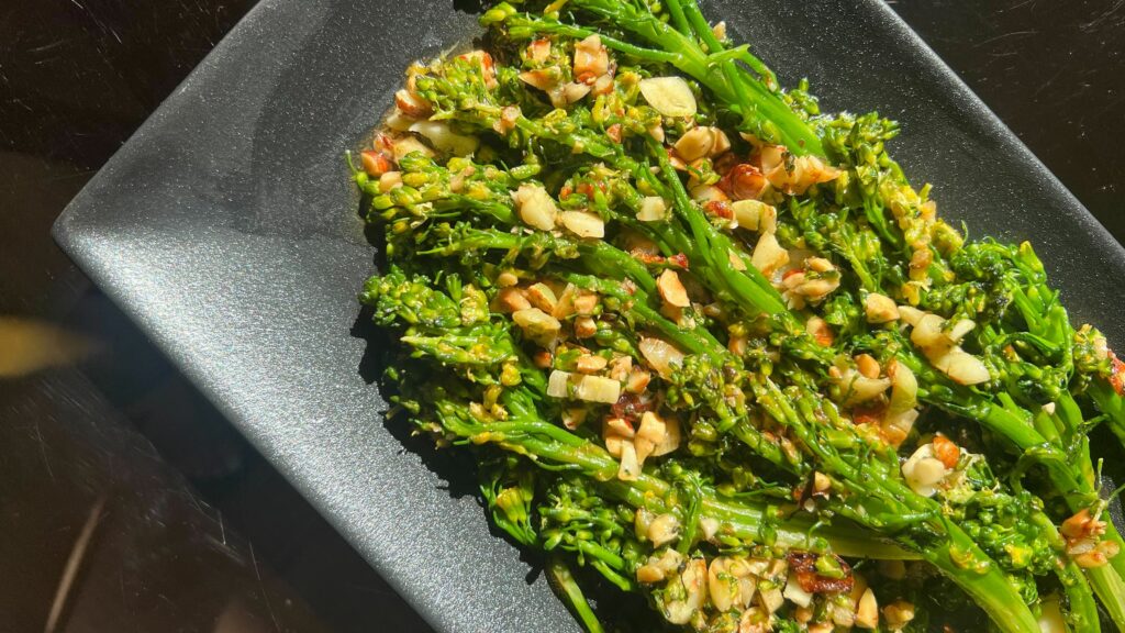 Brown Butter Hazelnut Broccolini plated on a serving dish.