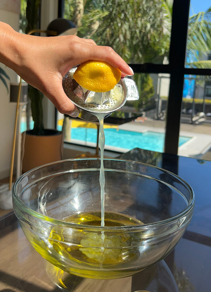 Olive oil and fresh lemon juice in a glass.
