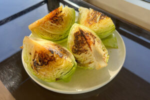 Four wedges of charred cabbage.