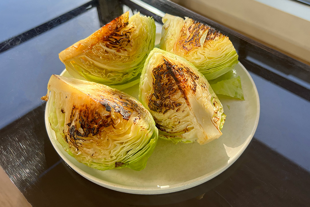Four wedges of charred cabbage.